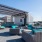 Rooftop lounge at our apartments for rent in Dallas, TX, featuring outdoor furniture and a view of the city.