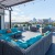 Rooftop lounge at our apartments for rent in Dallas, featuring outdoor couches and a view of the city skyline.