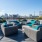 Rooftop lounge at our apartments for rent in Dallas, featuring outdoor couches and a view of the city skyline.