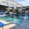 The pool area at our loft apartments in Downtown Dallas, featuring blue outdoor couches and fountains into the pool.