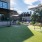 The dog park at our loft apartments in Dallas, TX, featuring astroturf, dog obstacles, and a view of the Mitchell Lofts.