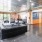 Lobby and entertainment room at our apartments in Deep Ellum, featuring black couches and a billiards table.
