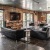 Lounge and lobby at our loft apartments for rent in Deep Ellum, featuring wood grain floor paneling and exposed brick.